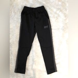 Nike track pants with pockets.   Draw string in the waist.  Good condition.